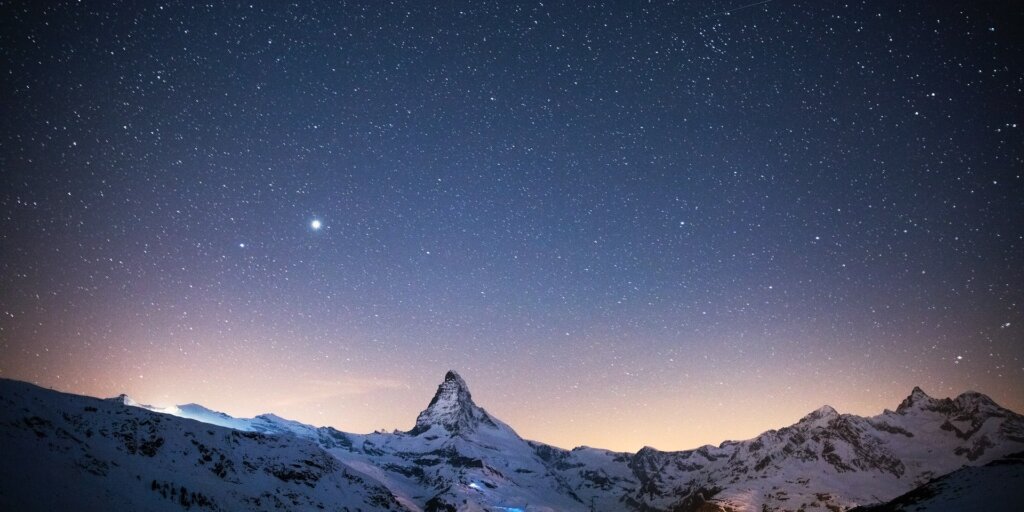 Sky at night with stars and mountains