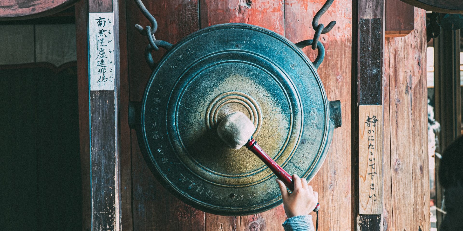 Nara, Japan, Boy bangs a gong.