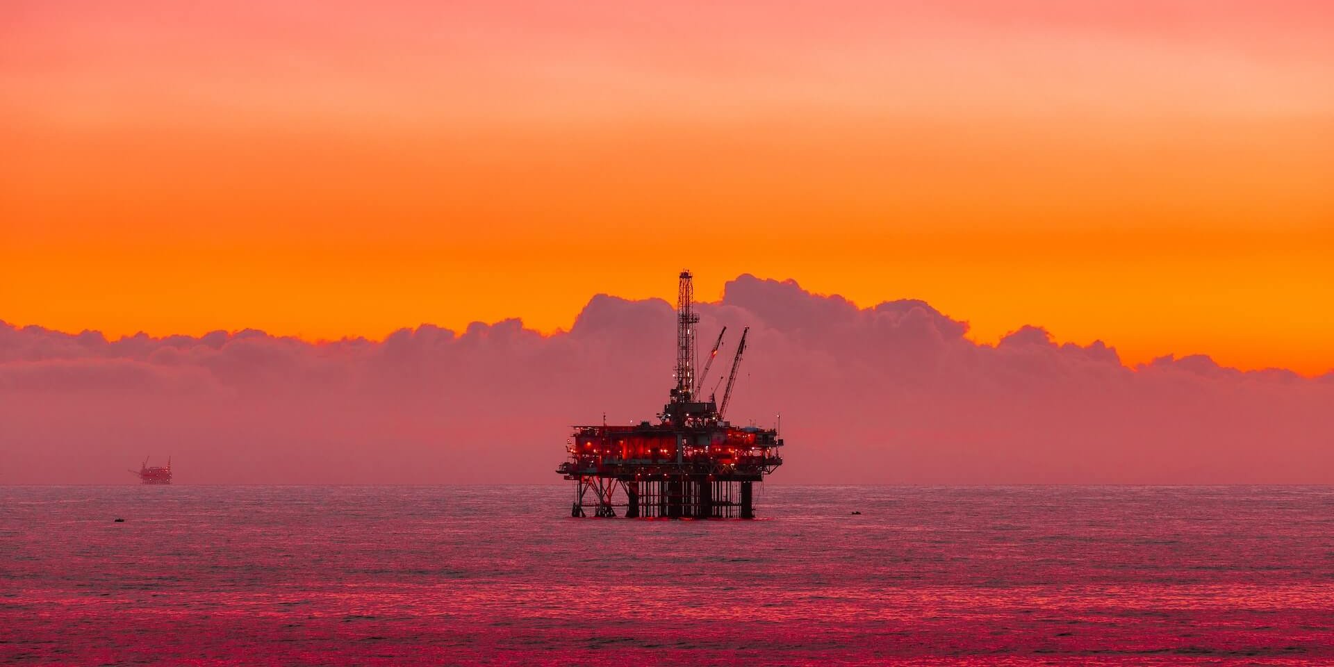 oil rig off shore with oil spill