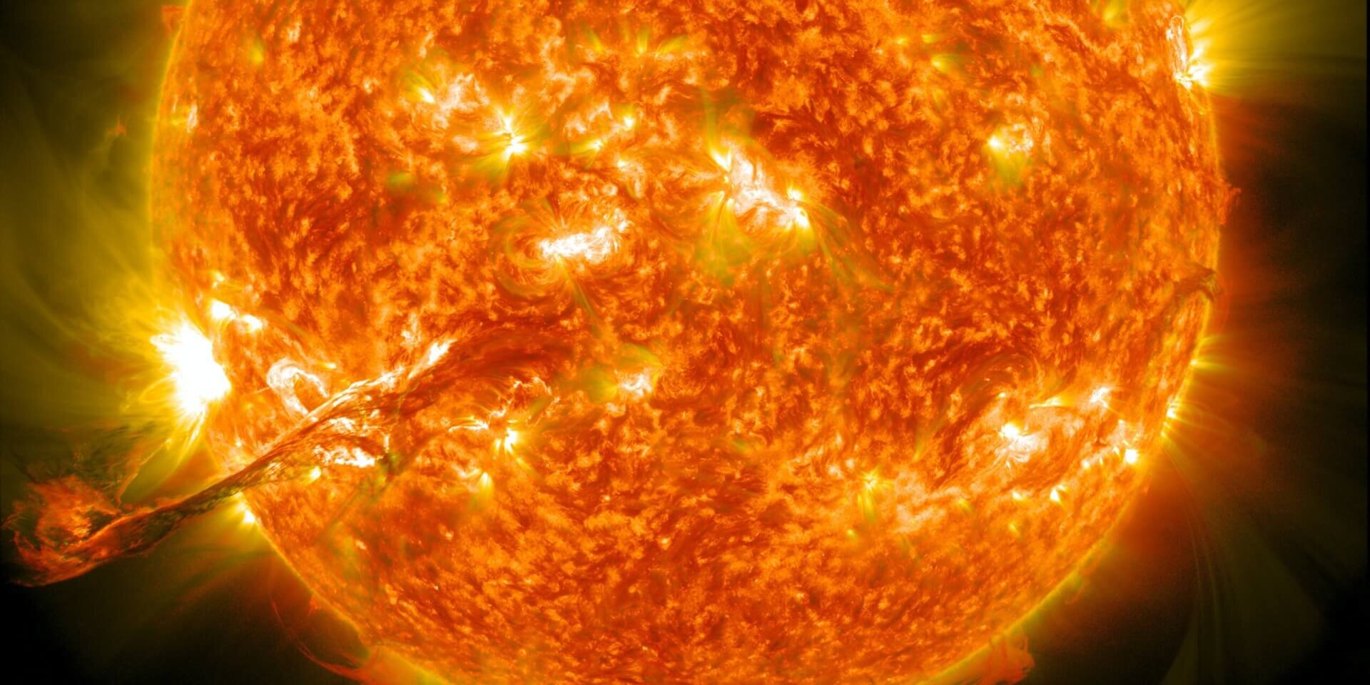 Image of the sun showing a coronal mass ejection erupting