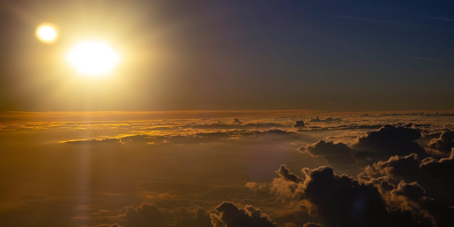 The sun shining over the clouds