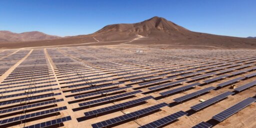 A landscape view of a desert with many solar cells