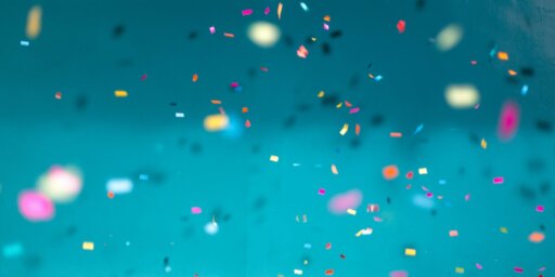 Colourful confetti falling down with a teal background
