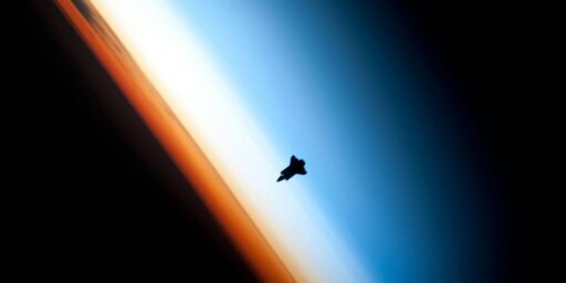 Space shuttle orbits above earth's atmosphere