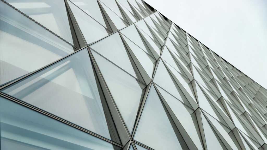 A close up view of a building with pyramid shaped glass windows