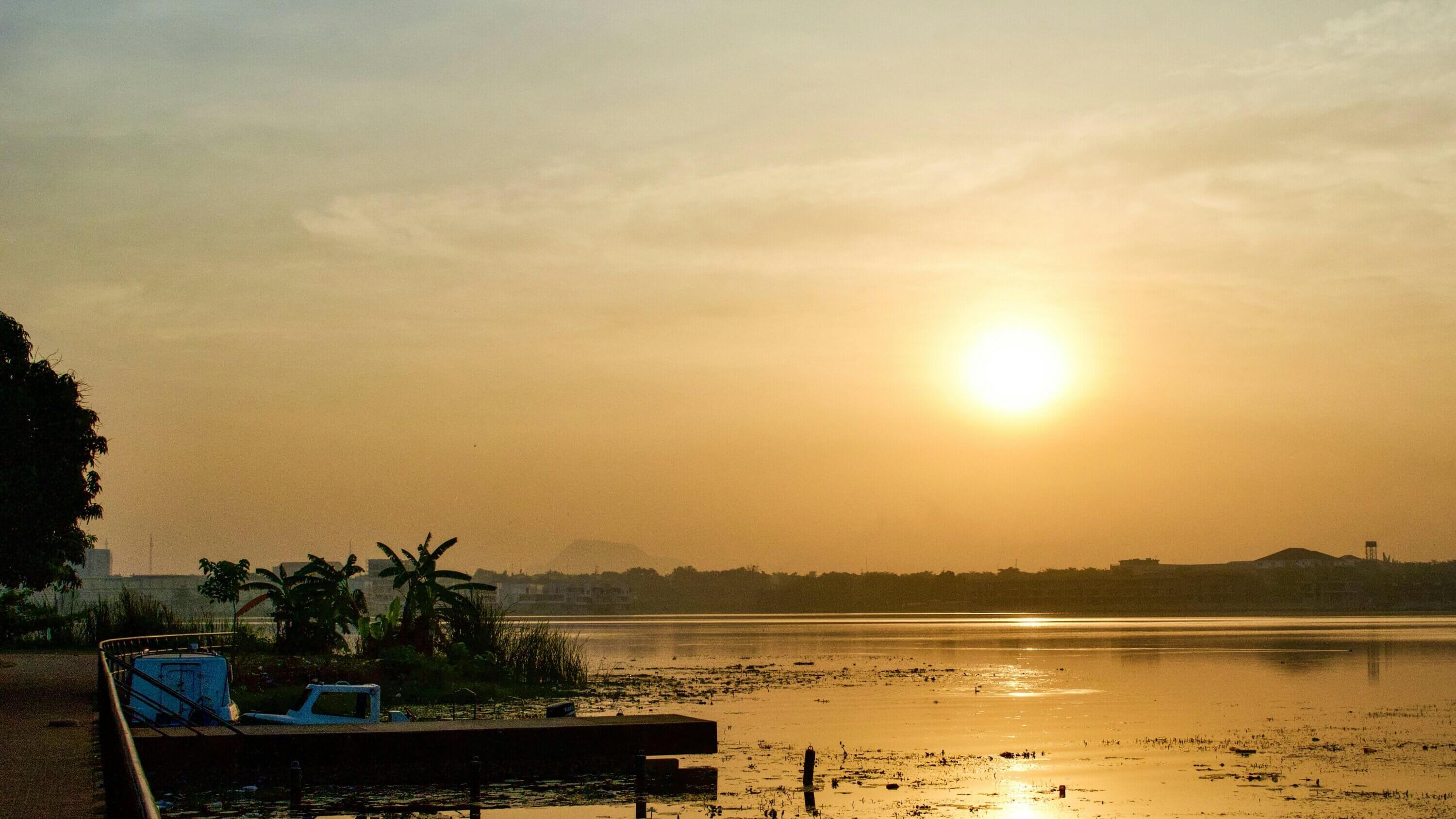 The sun setting above a lake in Abuja, Nigeria