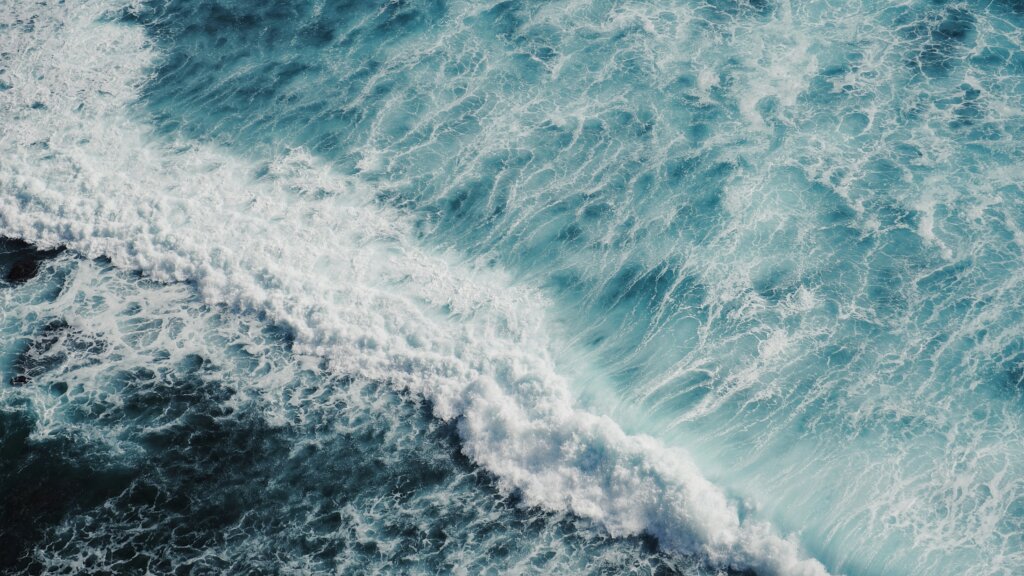 A bird's eye view of the ocean and water waves