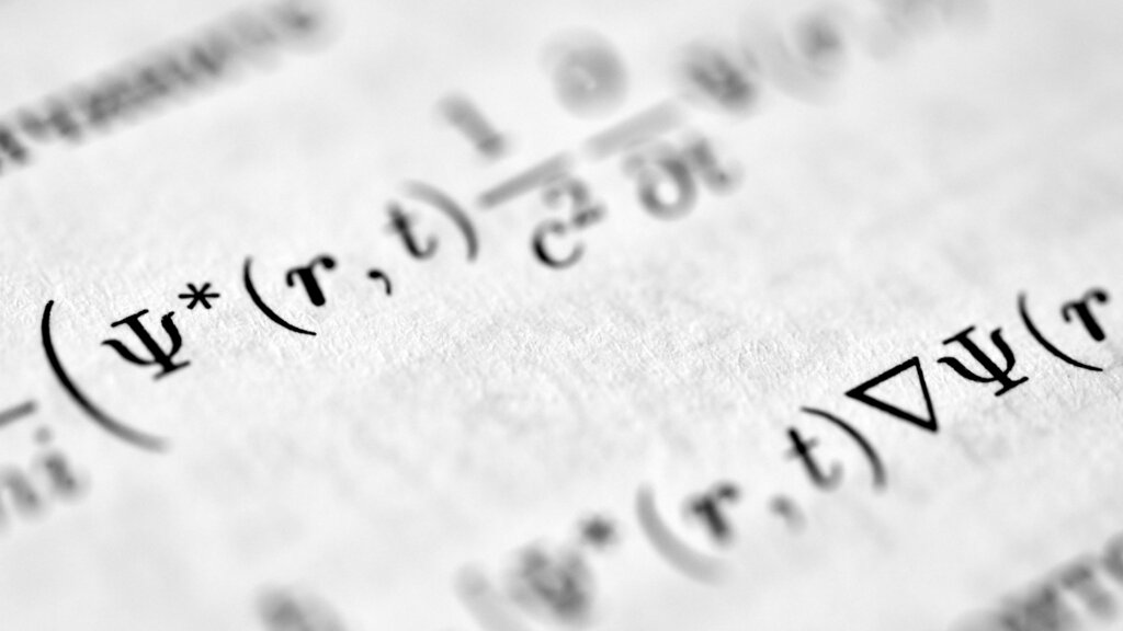 A close view of a paper with a mathematical equation written on it