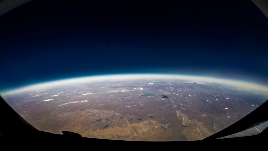 Earth seen from space through a glass window of a spaceship