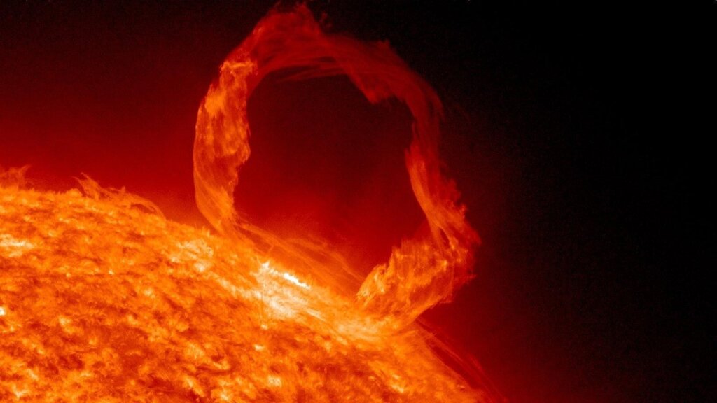 Solar prominence: a large loop of plasma arching away from the Sun along its magnetic field lines