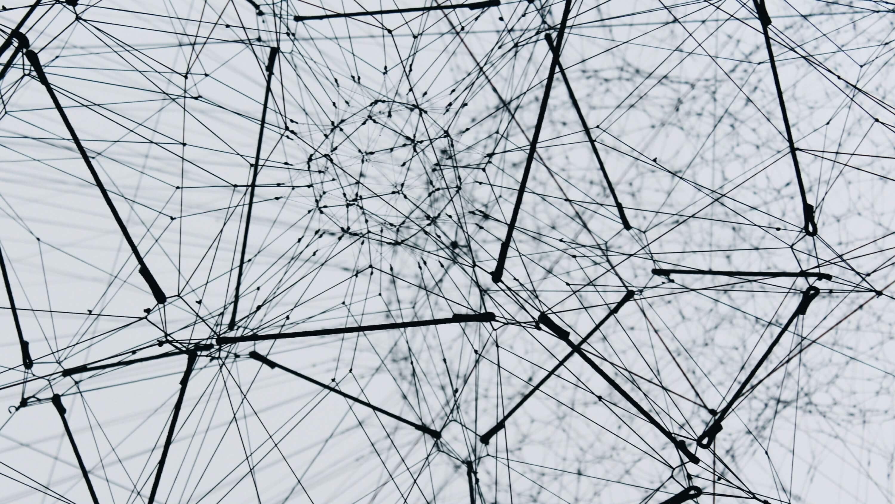 low angle photography of a metal structure: Algo-r-(h)-i-(y)-thms, 2018. Installation view at ON AIR, Tomás Saraceno's solo exhibition at Palais de Tokyo, Paris, 2018.