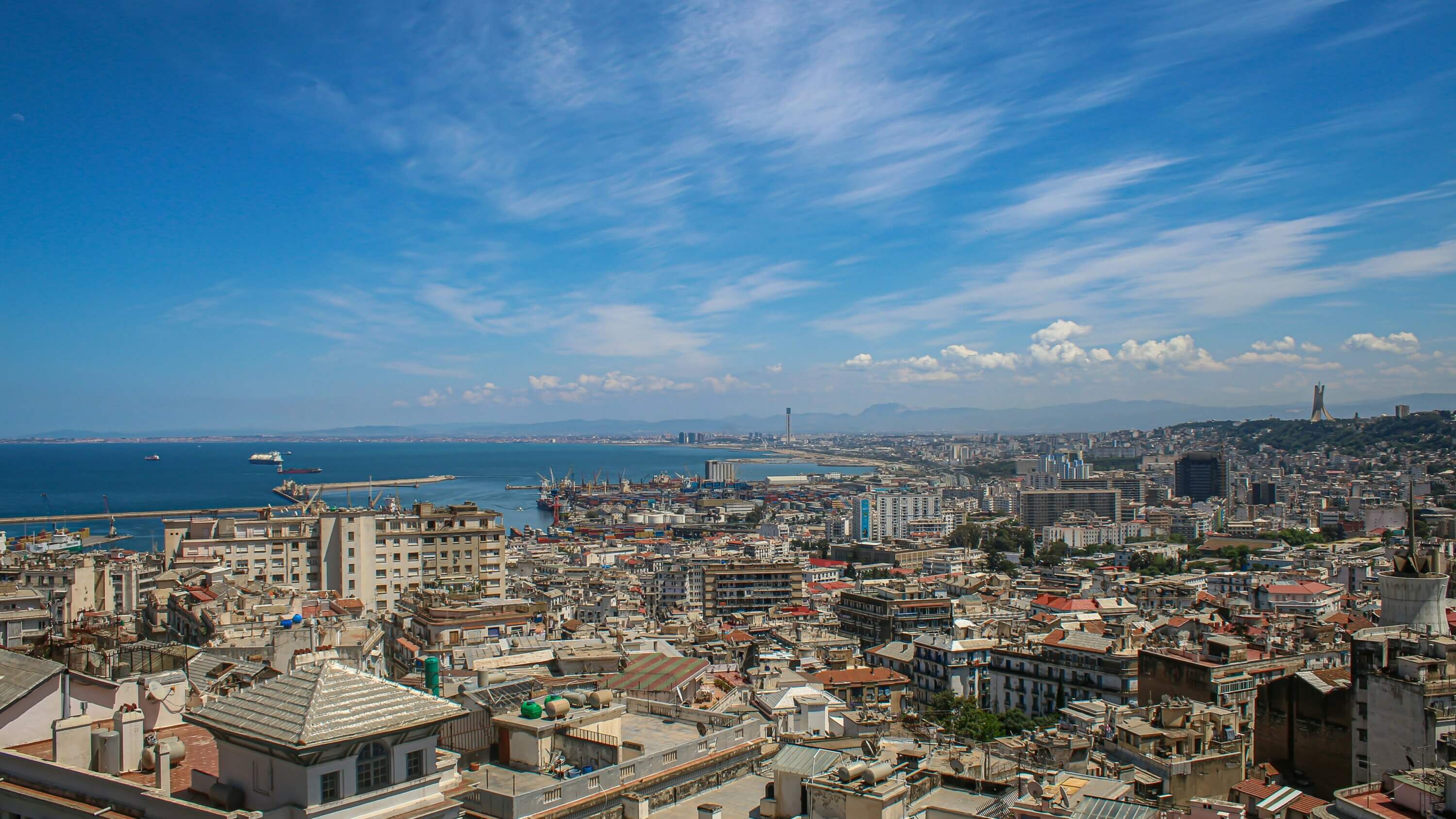 A view of Algiers city, capital of Algeria with buildings in the foreground and ocean in the background