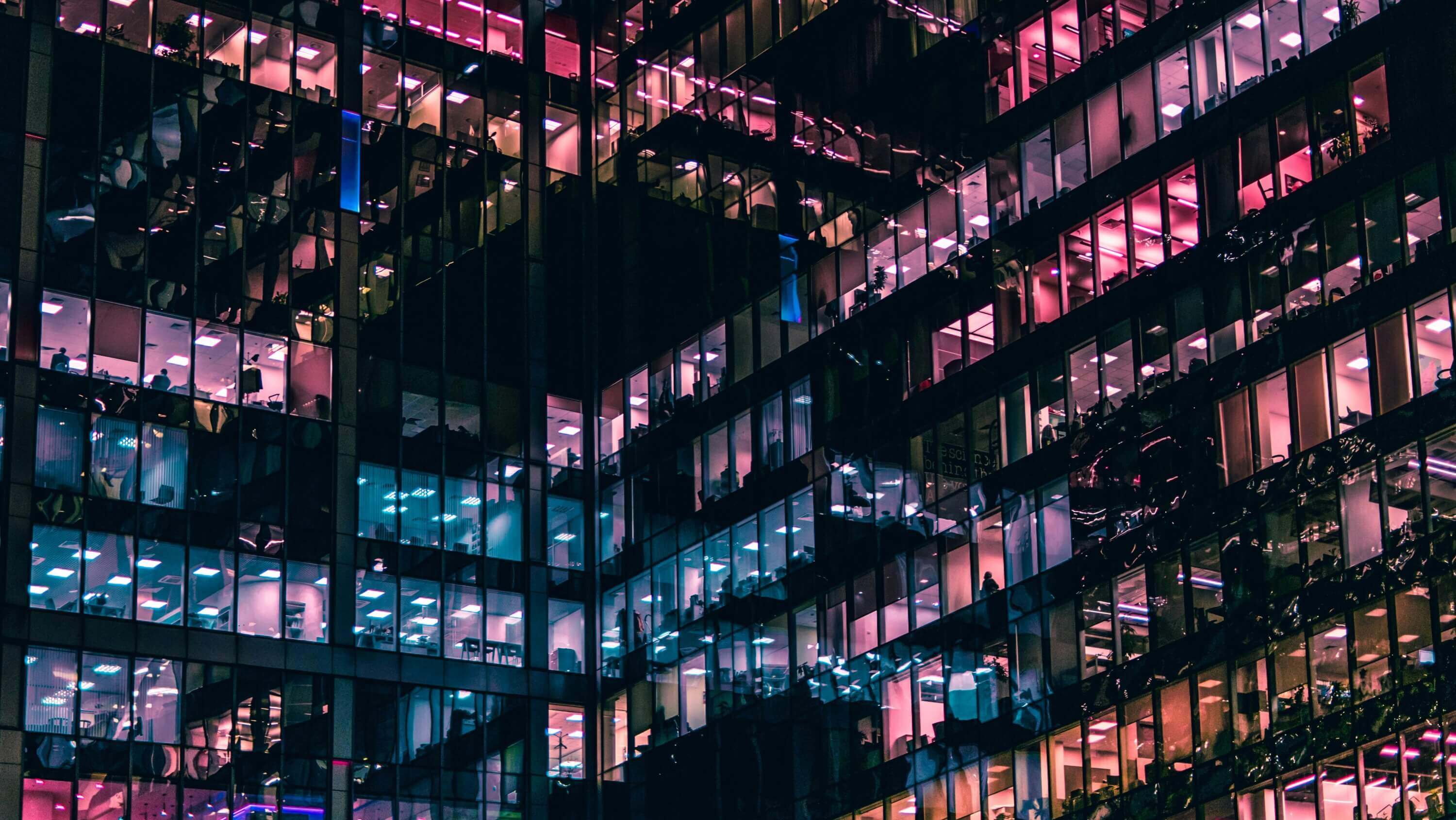 A photo of a building with people in it during night time