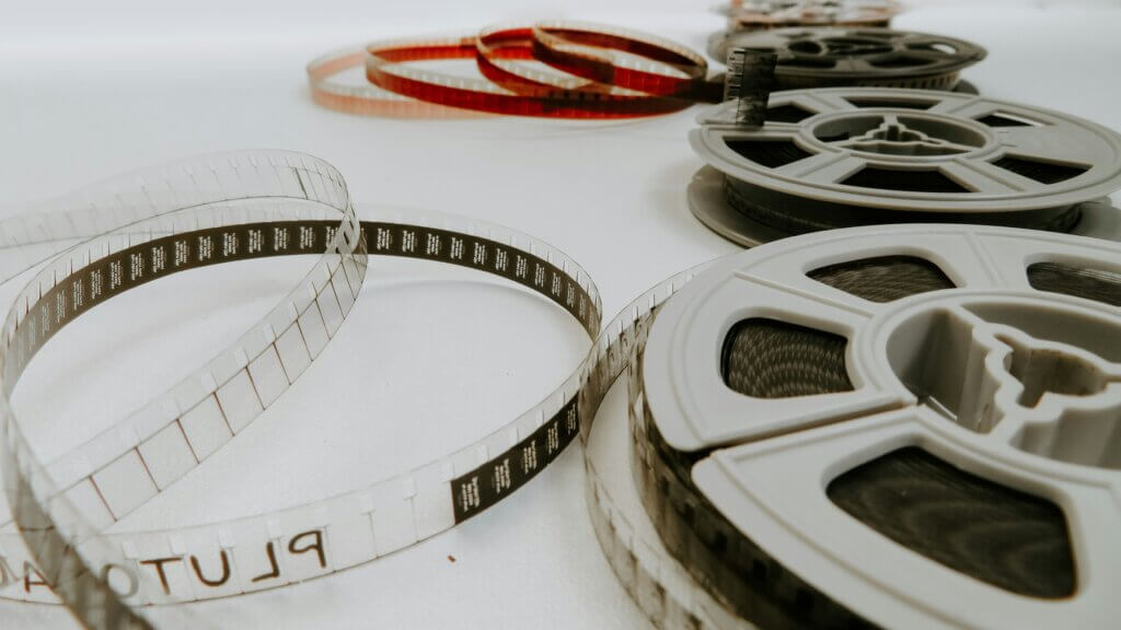 A photo of four 8mm reel films on a white table