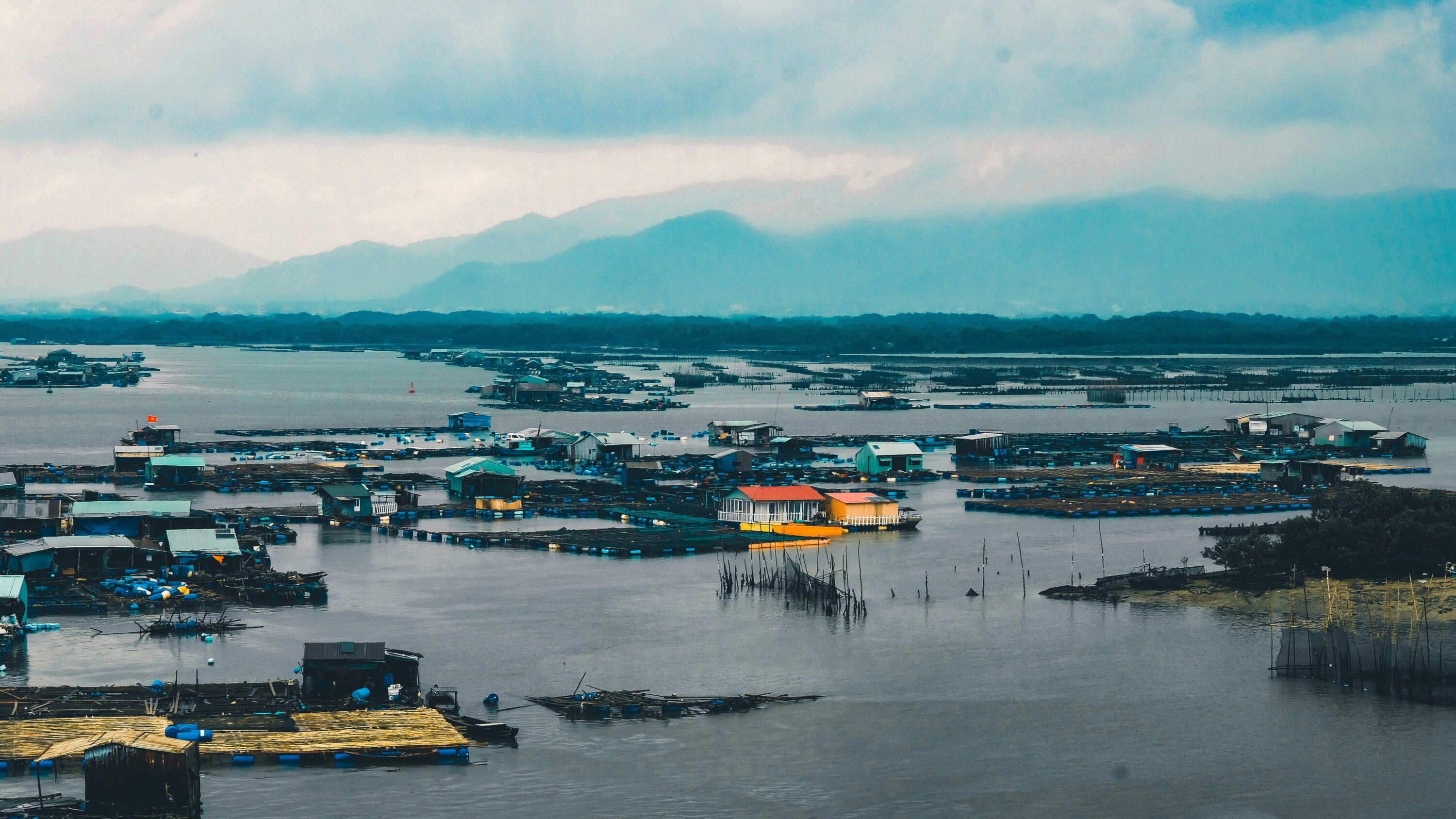 Houses surrounded with water under a cloud sky