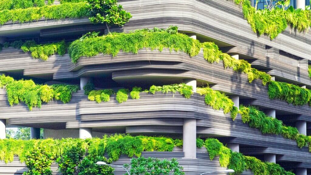 A parking lot building covered in greenery